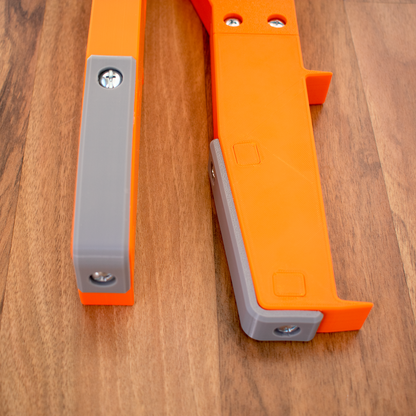 orange_deck_builder_spacing_tool_close_up_showcasing_top_face_and_rubber_bumpers
